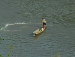HA SLO MO Man fishing Mekong River / Luang Prabang, Laos Stock Footage