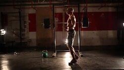 Bodybuilder exercising with a rope Stock Footage