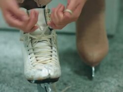 A female figure skater lacing up skates Stock Footage