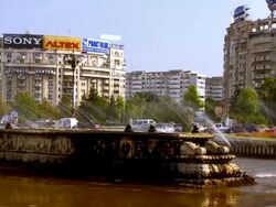 MS PAN Automobile traffic flowing around  fountain with communist era apartment buildings all around / Bucharest, Romania Stock Footage