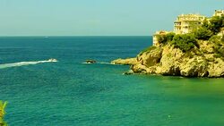 Turquoise water one home and small boat Majorca Stock Footage