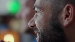 Guys sitting on couch watching tv and cheering Stock Footage