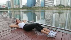Woman exercising sit ups outside Stock Footage