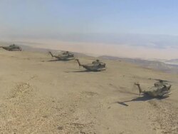 Aerial Military Helicopters on cliff in Desert, Arava, Israel Stock Footage