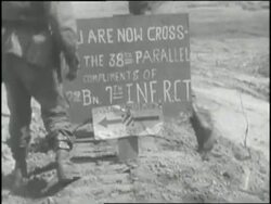 United States soldiers in Korea pass a sign marking the 38th Parallel. News Clip