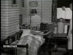 1948: HOSPITAL TESTING: CU Basal Metabolism procedure request slips. Patient resting in bed w/ oxygen mask over face, CU silver tank rising, falling. Doctor checking for leaks around close nose area. (measuring metabolic rate, BMR) Instructional Video
