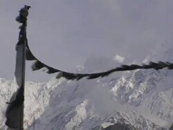 MS, PAN, Nepal, Jomsom, Tibetan Buddhist prayer flags with snow capped Annapurna mountains in background Stock Footage