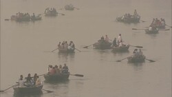 A flotilla of rowboats carries passengers across a river for the Diwali celebration in India. Stock Footage