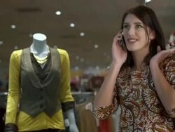HD DOLLY: Woman Talking On The Phone While Shopping Stock Footage