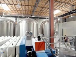 WS PAN modern micro brewery computer control panel and mash filter array with alternating color chambers of squeeze panels and solid panels and  large stainless steel fermentation vessels in background / Thousand Palms, California, USA Stock Footage