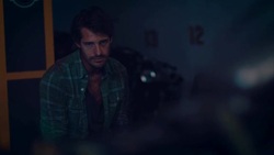 Man sitting in motorcycle workshop drinking coffe Stock Footage