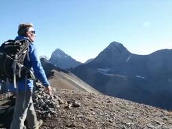 Hiker takes final steps to mountain summit Stock Footage