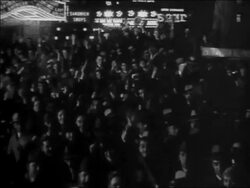B/W 1932 high angle crowd cheering + waving outdoors at night / election night Stock Footage