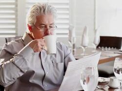 MS Businessman reading and drinking coffee at restaurant / Santa Fe, New Mexico, United States Stock Footage