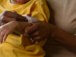 CU, TU, Mother applying bandage to son's arm (12-17 months), Richmond, Virginia, USA Stock Footage