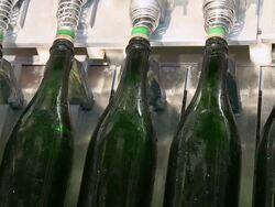 CU Champagne bottles on production line / Wiltingen, Saar-Valley, Rhineland-Palatinate, Germany Stock Footage
