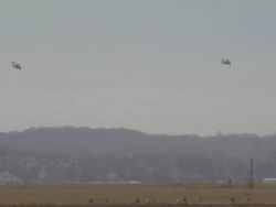 Two military helicopters flying over airport, USA Stock Footage