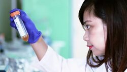 Scientist a look at test tube with liquid sample in laboratory, Slow motion Stock Footage