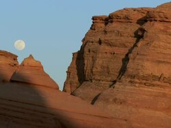 Full moon over desert red rock landscape - wide Stock Footage