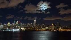 Manhattan, Moonrise over the  Empire State Building and Midtown Manhattan looking across the Hudson River, New York, United States of America - Time lapse Stock Footage