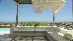 Curtains blowing on patio overlooking ocean Stock Footage