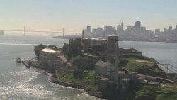 San Francisco Bay surrounds Alcatraz Island near Golden Gate Bridge and the San Francisco skyline. Stock Footage