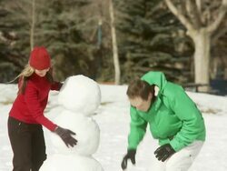 Family builds a snowman together Stock Footage