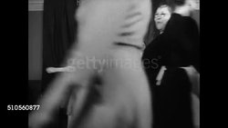 1947: LADIES' GARMENT UNION: DANCING: INT MS Union members square dancing male instructor clapping BG. MS Woman playing piano. MS Women dancing in pairs down line. Dance lessons recreation NYC ILGWU Instructional Video