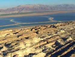 AERIAL POV WS View of  Low ride towards north of dead sea salt formations and cliff / Sourn Judea Desert, Israel  Stock Footage