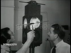1938: EXPERIMENTAL TECHNOLOGY: Two men working w/ radio controlled traffic light, light changing simultaneously red one side & green on other. Microwave traffic control board, inventor William Halsted holding handheld selector. Instructional Video