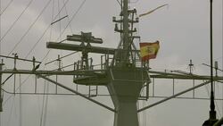 Radar equipment spins and the Spanish flag waves from the top of a surfaced submarine. Stock Footage
