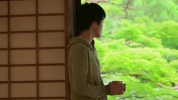 Young Japanese man holding Japanese tea at the temple. Kyoto, Japan. Stock Footage