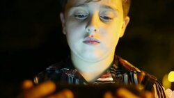little boy reading on his tablet in the dark Stock Footage