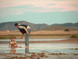Small child playing in the mud. Stock Footage