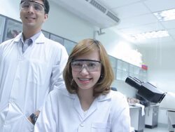 HD : Scientist Couple using microscope [Zoom out] Stock Footage