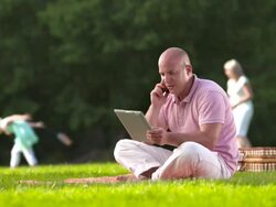 HD DOLLY: Father Working While Having Picnic With Family Stock Footage