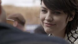 Young woman smiles and talks with boyfriend over coffee at outdoor caf_ Stock Footage