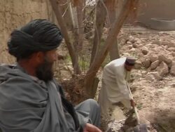 MS PAN ZI Soldier investigating with civilian / Musa Qala, Helmand Province, Afghanistan. Stock Footage