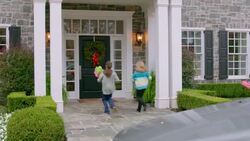 Excited family arrives at grandma's house for Christmas (dolly-shot) Stock Footage