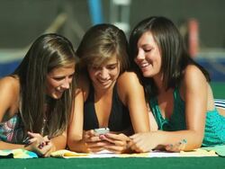three girls at a water park looking at a cell phone Stock Footage
