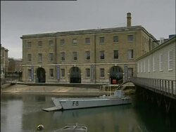 Portsmouth, Action Stations Activities: boats in dock, boy climbing wall and video game. 2004; short sequence. Stock Footage
