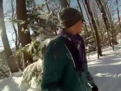 POV of a young man snowboarding through trees and jumping in the winter. - Slow Motion - Model Released - HD Stock Footage