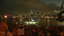 Spectators at the edge of Sydney Harbour await midnight on New Year's Eve. Stock Footage