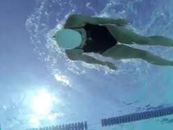 MS PAN SLO MO Shot of female, baby boomer, swimmer performs flip turn in underwater / Davis, California, United States  Stock Footage