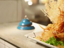 MS PAN Cook/Chef preparing a prawn tempura dish typical Japanese food final dish and someone ringing the bell to show it travelling / Sao Paulo, Brazil Stock Footage