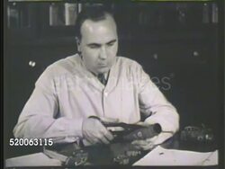 1935: MOTOR HOSE TESTING: MS Engineer sitting at table cutting open motor hose connection '#39.' MCU Opening inner wall of hose, revealing little to no decay or rot, male hands running through surface. Antifreeze Instructional Video