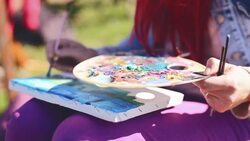 Red head woman painting on mountain Stock Footage