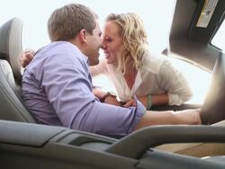 MS Shot of young couple embracing and smiling in front seat of car on sunny day in urban area / Saint Paul, Minnesota, United States Stock Footage