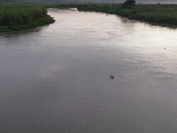 Exterior moving shot from the water up to the hills in the background in Kigali Stock Footage