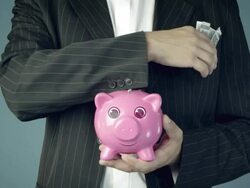 Male hand putting dolar bill into animated piggy bank Stock Footage